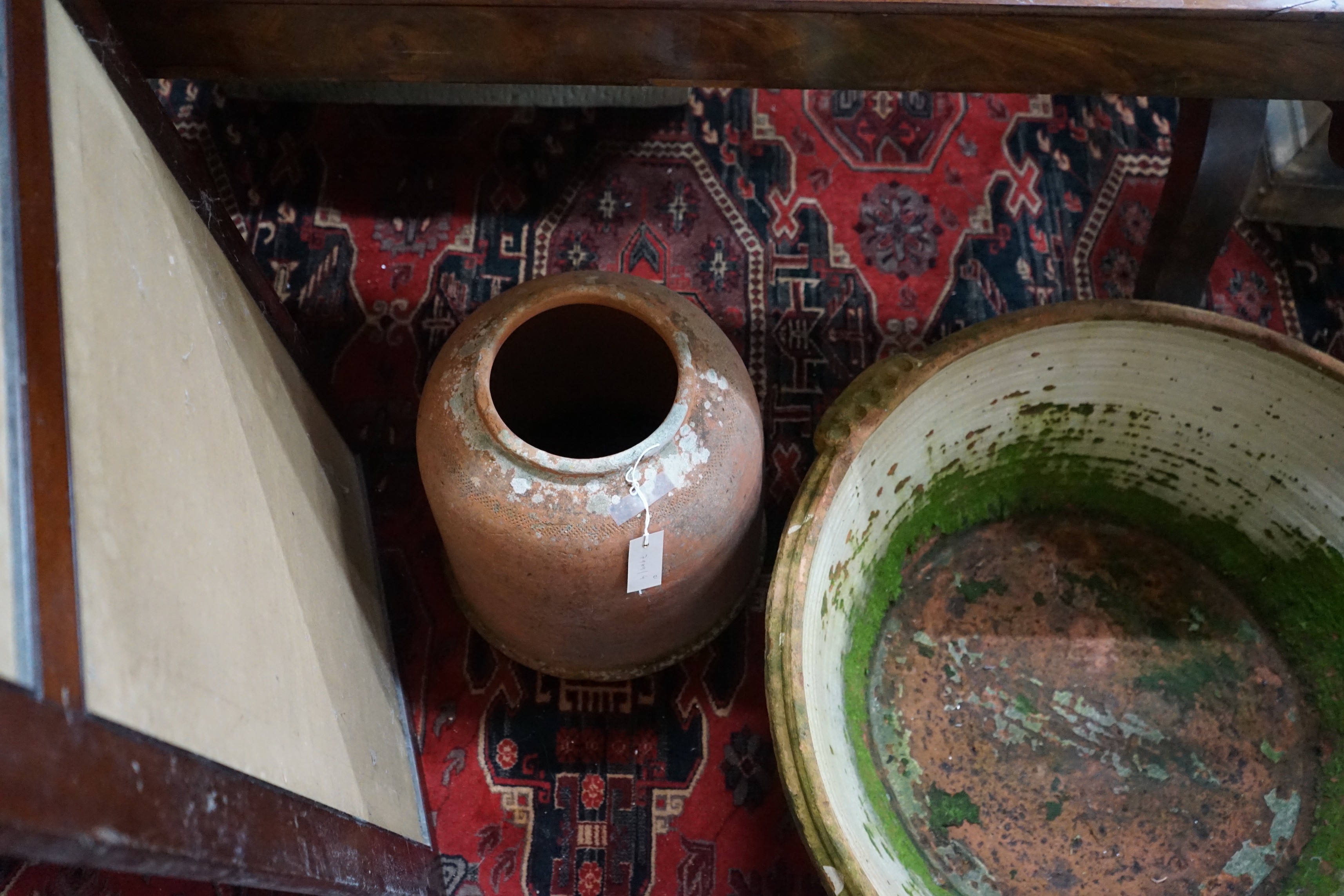 A large circular terracotta pail and a rhubarb planter, larger width 84cm, height 30cm